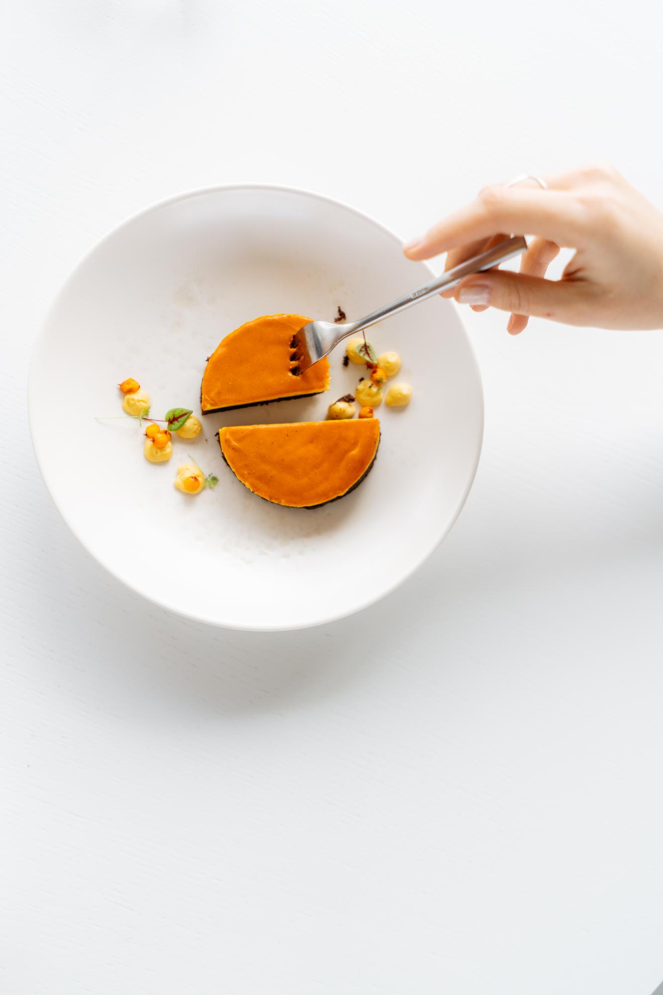 Food stylist arranging a plate in studio